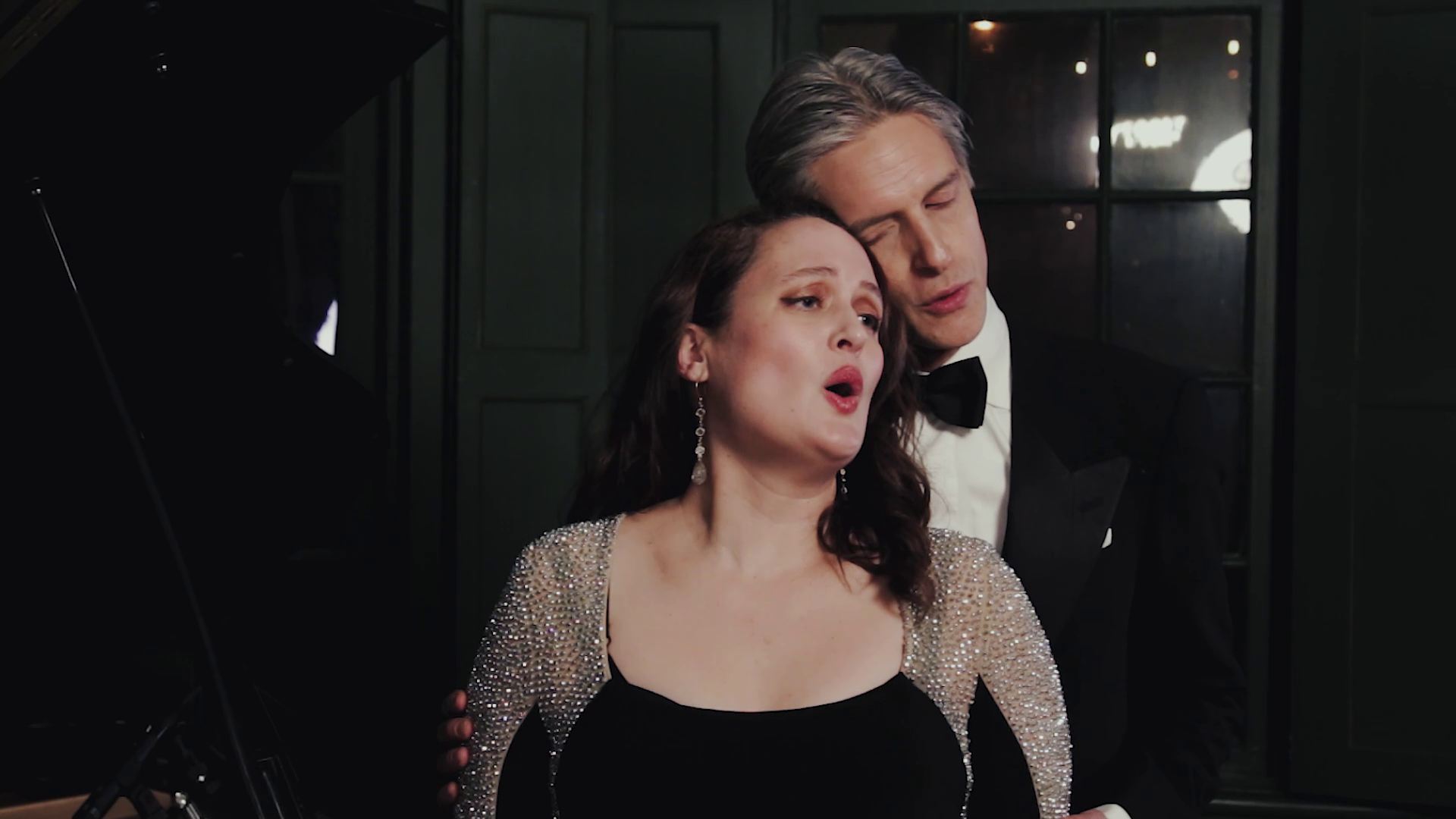 Duo performing in evening dress beside the grand piano