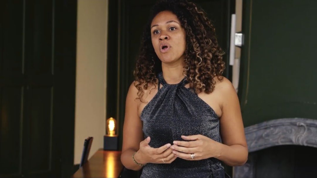 Soprano singing in an off-shoulder black dress