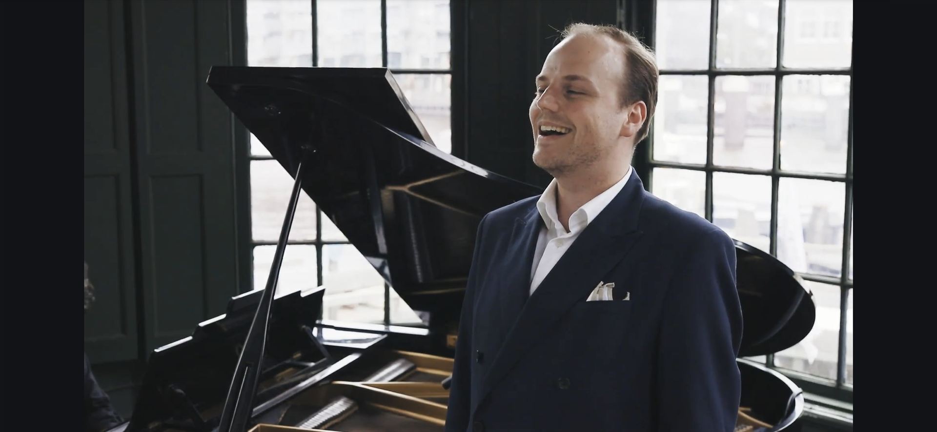 Tenor singing beside the grand piano